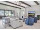 Comfortable living room with high ceilings, wooden beams, a gray sofa, and a view of the backyard at 5001 Night Star Trl, Odessa, FL 33556
