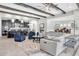 Open-concept living area with a kitchen, dining, and living room, featuring high ceilings with wood beams and stylish furniture at 5001 Night Star Trl, Odessa, FL 33556