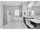 The stunning bathroom features a separate tub and shower, double sinks, and marble-look tiling at 5001 Night Star Trl, Odessa, FL 33556