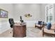 Home office features custom desk, seating area and natural light at 5001 Night Star Trl, Odessa, FL 33556