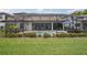 Screened-in pool area features a relaxing lounge area and well-maintained landscaping at 5001 Night Star Trl, Odessa, FL 33556