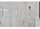 This elegant shower features marble-look tiling, a built-in seat and modern fixtures at 5001 Night Star Trl, Odessa, FL 33556