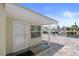 Waterfront back porch featuring a paver patio and direct access to the canal and boat docks at 5045 Pelican Dr, New Port Richey, FL 34652
