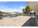View of the waterfront from the paved backyard patio area with dock access and lovely landscaping at 5045 Pelican Dr, New Port Richey, FL 34652
