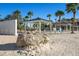 Beautiful community beach with covered picnic areas and palm trees; the perfect spot to relax at 5045 Pelican Dr, New Port Richey, FL 34652