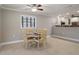 Cozy dining area next to the kitchen, featuring a round wooden table and stylish chairs at 5045 Pelican Dr, New Port Richey, FL 34652