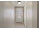 Bright entryway with neutral walls, tiled floor, and a glass-paneled front door at 5045 Pelican Dr, New Port Richey, FL 34652