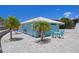 Charming blue building with white trim surrounded by palm trees and a stylish outdoor dining set at 5045 Pelican Dr, New Port Richey, FL 34652