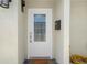 Close-up of the front door featuring a glass window and a welcoming doormat at 5045 Pelican Dr, New Port Richey, FL 34652