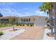 Charming single-story home featuring a brick driveway, stone accents, and well-manicured landscaping at 5045 Pelican Dr, New Port Richey, FL 34652