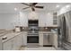 Updated kitchen featuring stainless steel appliances, granite counters, and white cabinetry at 5045 Pelican Dr, New Port Richey, FL 34652