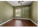 Comfortable bedroom features hardwood floors, a window, and neutral walls at 5487 Valley View Dr, Brooksville, FL 34601