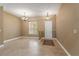 Formal entryway with tile flooring, a chandelier, and a front door with sidelight at 5487 Valley View Dr, Brooksville, FL 34601