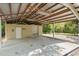This spacious garage features a metal roof, concrete floor, and convenient roll-up door for easy access at 5487 Valley View Dr, Brooksville, FL 34601