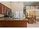 Open kitchen with a kitchen island featuring bar seating, stainless steel appliances, and a spiral staircase at 5487 Valley View Dr, Brooksville, FL 34601