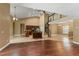 Open-concept living room features wood flooring, a spiral staircase, and a modern kitchen with an island at 5487 Valley View Dr, Brooksville, FL 34601