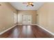 Spacious room with wood floors, neutral walls, and access to outdoor space through elegant French doors at 5487 Valley View Dr, Brooksville, FL 34601