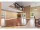 Bright living area with a cozy fireplace, high ceiling, wood floors, and French doors to the outdoor at 5487 Valley View Dr, Brooksville, FL 34601