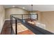 Spacious loft area with modern railing overlooking the floor below and a ceiling fan at 5487 Valley View Dr, Brooksville, FL 34601