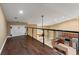 Open loft space overlooking the kitchen with modern railing and a door for storage at 5487 Valley View Dr, Brooksville, FL 34601
