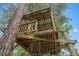 Custom-built playhouse features a climbing net for hours of fun and imaginative play at 5487 Valley View Dr, Brooksville, FL 34601