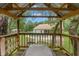 Backyard playhouse with picnic table overlooks the swimming pool and fire pit area at 5487 Valley View Dr, Brooksville, FL 34601
