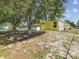 Exterior view of the home featuring the screened-in pool and spacious backyard at 6028 Dorset Rd, Spring Hill, FL 34608