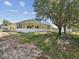 Exterior view of the home featuring the screened-in pool and spacious backyard at 6028 Dorset Rd, Spring Hill, FL 34608