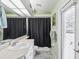 Bathroom featuring modern sink, grey wood floors and shower with black curtain at 6028 Dorset Rd, Spring Hill, FL 34608