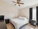 Comfortable bedroom with a ceiling fan and a window to let in the natural light at 6028 Dorset Rd, Spring Hill, FL 34608