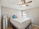 Bedroom with a large bed, mirror, and window to let in the natural light at 6028 Dorset Rd, Spring Hill, FL 34608