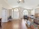Open-concept living room with wood floors, neutral walls, and abundant natural light at 6028 Dorset Rd, Spring Hill, FL 34608