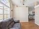 Well-lit living room with wood floors, arched windows, chandelier, and comfortable seating at 6028 Dorset Rd, Spring Hill, FL 34608