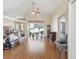 Open living room with wood floors, vaulted ceilings, and sliding glass doors to backyard at 6028 Dorset Rd, Spring Hill, FL 34608