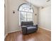 Bright living room with wood floors, large window, and comfortable seating area at 6028 Dorset Rd, Spring Hill, FL 34608