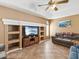 Comfortable living room with built-in shelving, tile flooring, and a ceiling fan at 6028 Dorset Rd, Spring Hill, FL 34608