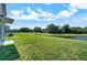 Expansive green backyard featuring a picturesque water view, perfect for outdoor relaxation and enjoyment at 6222 Cherry Blossom Trl, Gibsonton, FL 33534