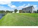 Huge backyard with a pond view featuring a bright green lawn with plenty of room to enjoy the outdoors at 6222 Cherry Blossom Trl, Gibsonton, FL 33534