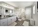 Bathroom featuring double vanity, granite countertops, shower, and a white trim at 6222 Cherry Blossom Trl, Gibsonton, FL 33534