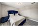 Bedroom showcasing a tufted blue bed set, hard floors, and a crystal light fixture at 6222 Cherry Blossom Trl, Gibsonton, FL 33534