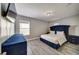 Bedroom with a blue bed set, hard flooring, and natural light from the window at 6222 Cherry Blossom Trl, Gibsonton, FL 33534
