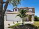 Beautiful two-story home with a well-manicured lawn, decorative rock garden, and charming curb appeal at 6222 Cherry Blossom Trl, Gibsonton, FL 33534