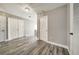 Hallway with hard flooring, leading to rooms with white doors and white trimming at 6222 Cherry Blossom Trl, Gibsonton, FL 33534