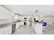 Bright kitchen with white cabinets, stainless steel appliances, and a central island with seating at 6222 Cherry Blossom Trl, Gibsonton, FL 33534