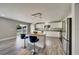 Well-lit kitchen featuring stainless steel appliances, an island with seating, and sleek countertops at 6222 Cherry Blossom Trl, Gibsonton, FL 33534