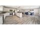 Bright kitchen featuring stainless appliances, white cabinetry, granite counters, and an island with seating at 6222 Cherry Blossom Trl, Gibsonton, FL 33534