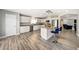 Modern kitchen with white cabinets, stainless steel appliances, granite countertops, and a breakfast bar at 6222 Cherry Blossom Trl, Gibsonton, FL 33534