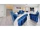 Elegant living room with plush blue seating, stylish decor and a fireplace feature wall at 6222 Cherry Blossom Trl, Gibsonton, FL 33534