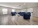 Elegant living room with hardwood floors, recessed lighting, and plush blue furniture at 6222 Cherry Blossom Trl, Gibsonton, FL 33534