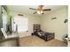This is a well-decorated bedroom, features a ceiling fan and natural light from the window at 6309 Covewood Dr, Spring Hill, FL 34609